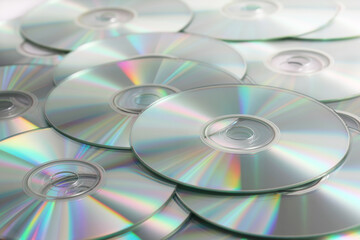 Heap of DVD, CD disks on white