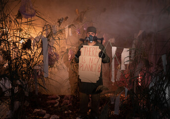 man in a gas mask holding poster with words there is No Planet B. burning plastic trash and smoke...