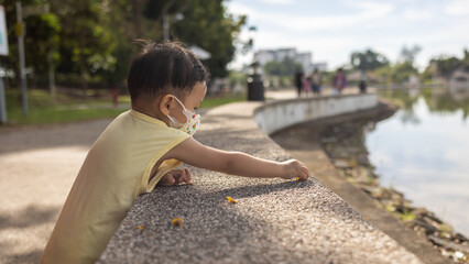Portrait image of Happy 1-2 years old Asian Chinese child enjoying playing on park