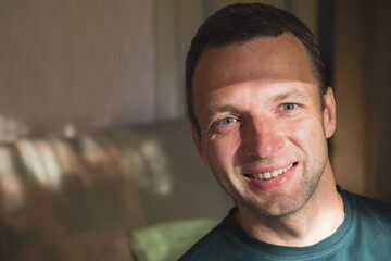 Studio face portrait of smiling young adult Caucasian man