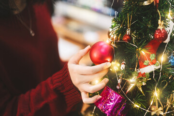 Woman hand decorating christmas tree prepare celebration on december festival at home