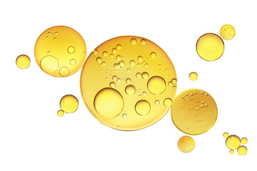 Golden yellow abstract oil bubbles or face serum isolated on white background. Oil bubbles macro...
