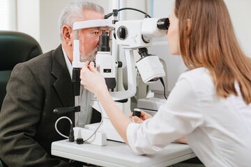 ophthalmologist examination of elderly man with slit lamp. medical equipment