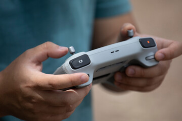Close up of Young man's hands on remote controller while flying a drone.