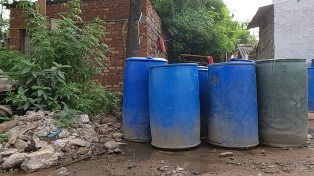 Drinking and bathing water filled in containers for people living in slum area