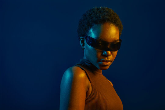Woman in futuristic eyeglasses over dark studio background