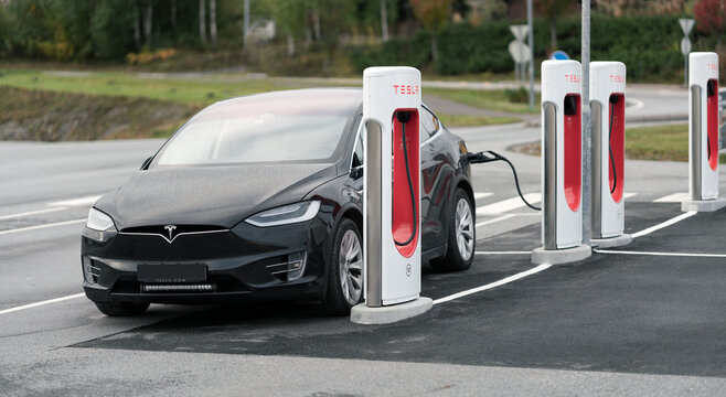 Tesla model x charging at tesla charging point. Ev and technology concept.