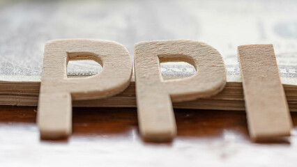 Text PPI message is placed on the dollar and gold bar. PRODUCER PRICE INDEX (PPI) numbers on the dollar concept.