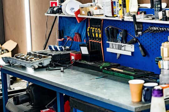 Large workbench with tools at station for vehicle technical servicing