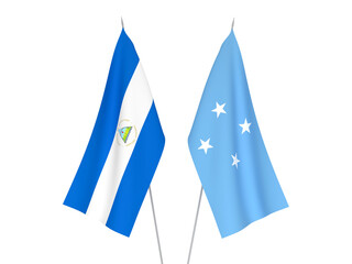 Obraz premium National fabric flags of Nicaragua and Federated States of Micronesia isolated on white background. 3d rendering illustration.