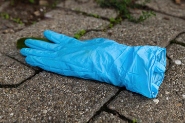 medical glove as garbage on the ground