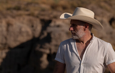 Adult man in cowboy hat in desert. Almeria, Spain