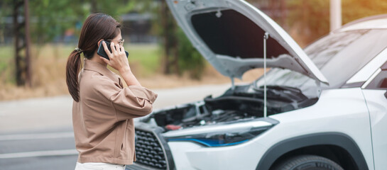 woman driver using mobile phone during problem car. Breakdown or broken car on road. Vehicle...