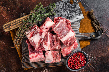 Butcher board with Raw diced beef and lamb meat ready for cooking. Dark background. Top view