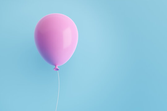 Pink flying air helium balloon against blue background.