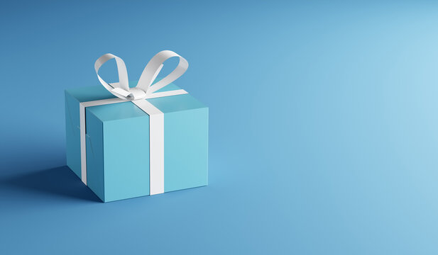 Blue gift box with white ribbon on blue background with copy space.