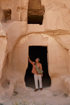 Young woman touring cave in Cappadocia. Open Air Museum, National Park. Turkey. High quality photo