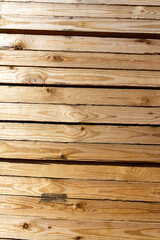 Naklejka premium Blocks of pine sawn timber for the construction of roof houses and cottages stacked on the lumberyards site, ready for sale