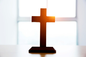 Small wooden cross on table