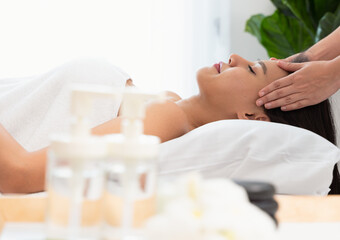 Obraz na płótnie Canvas Face massage. Attractive young woman getting spa massage treatment at spa salon..