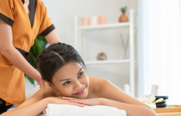 Obraz na płótnie Canvas Attractive woman enjoying Thai massage in spa salon.