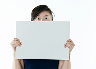 Fototapeta premium Woman hides face behind white board