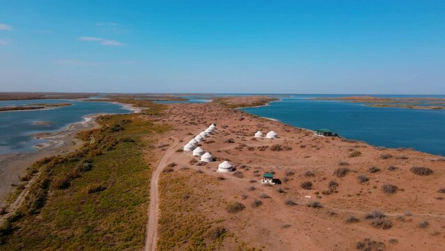 Drone flight over yurts on the shore of Lake Aydarkul