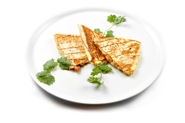 Quesadilla with cheese and chicken in a white plate. Close-up, selective focus. White background.