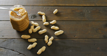 Image of close up of peanut butter on wooden background