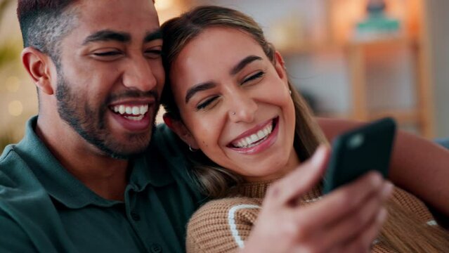 Couple phone, social media meme and kiss on forehead for love, streaming comic video on the internet and funny conversation on couch in home. Man and woman happy reading notification with affection