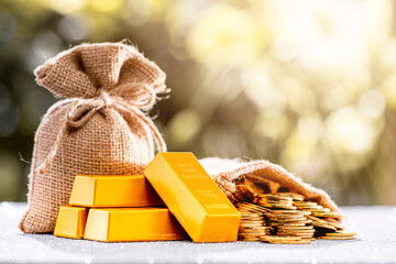 Many gold coins were put in the money bag and have gold bars placed together. Wealth obtained from...