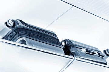 Luggage on shelf in modern train interior