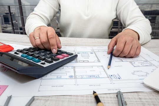 a man working on a drawing to create his home with professional design skills.