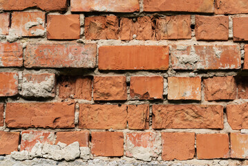 Obraz premium Old weathered brick non-plastered wall surface close-up
