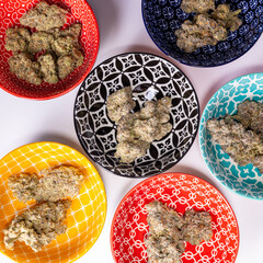 Colorful Bowls on a white background filled with different strain of Cannabis