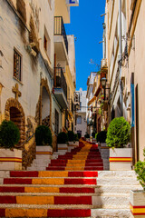 Fototapeta na wymiar antique staircase in Calpe, Spain in the old town painted red and yellow in the color of the country's flag