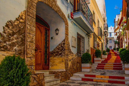 Fototapeta  antique staircase in Calpe, Spain in the old town painted red and yellow in the color of the country's flag