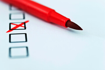 Red pen marks checkbox with a cross