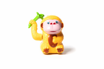Plastic toy monkey isolated on white background.