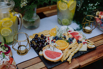 Close-up of dessert buffet at small wedding reception outside in the backyard.