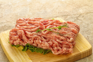 Raw minced pork meat over board