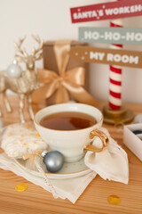 Tea in a large white cup with Christmas decorations