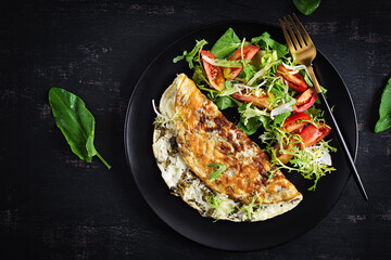 Ketogenic diet breakfast. Omelette with sorrel and tomatoes salad. Top view, copy space