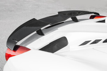 Modern supercar carbon spoiler wing at the trunk
