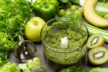 Green smoothie in blender bowl.