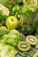 Fototapeta na wymiar Kiwi, apple and lettuce on table. Green smoothie in blender bowl.