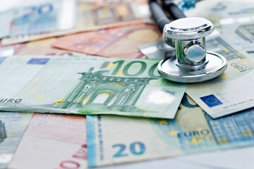 Stethoscope on heap of European currency