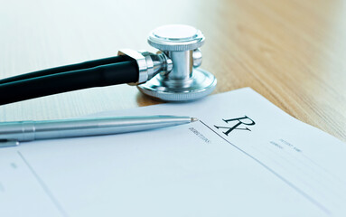 Medical prescription, stethoscope and pen on doctor desk