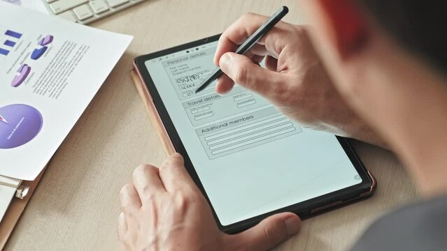 Over the shoulder shot of unrecognizable candidate filling out online application form on digital tablet before job interview in modern office