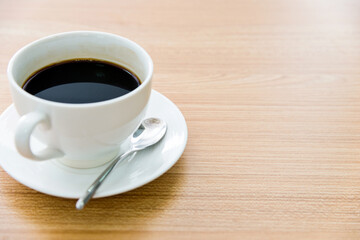 Cup of coffee on wooden table